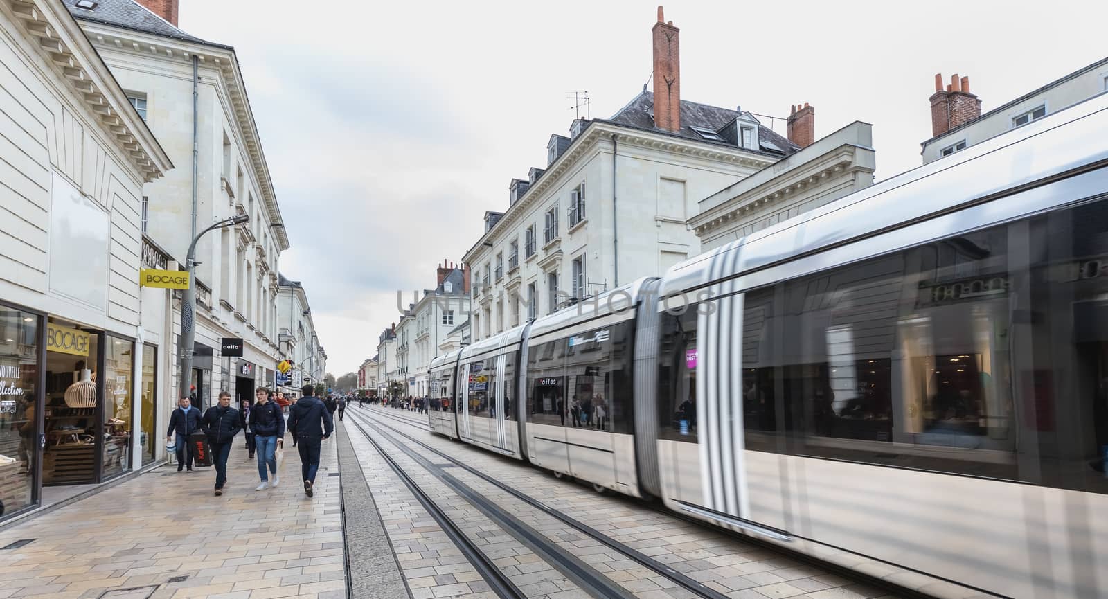 Tours, France - February 8, 2020: Electric tram rolling in a pedestrian street in the historic city center on a winter day