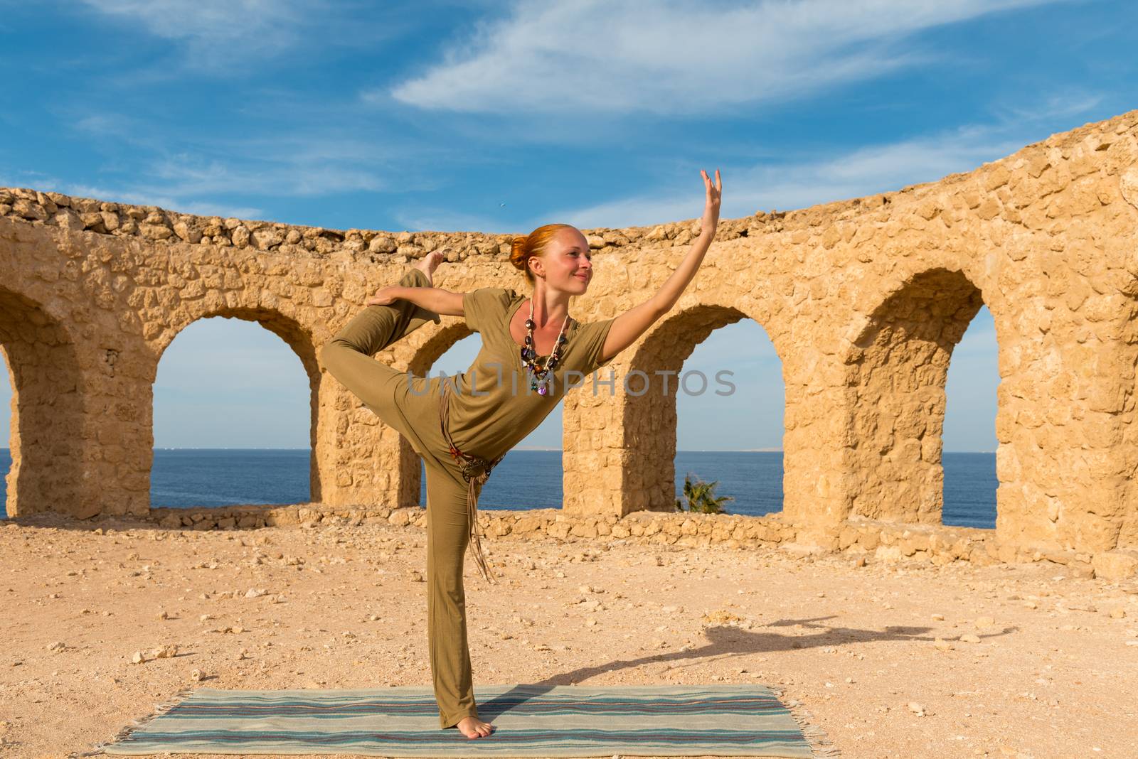 Woman doing yoga asana at exotic ancient location