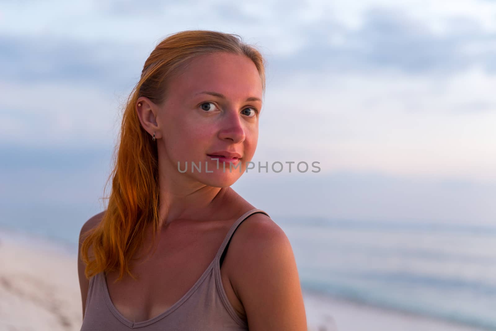 Young woman enjoying sunset view at tropical island beach