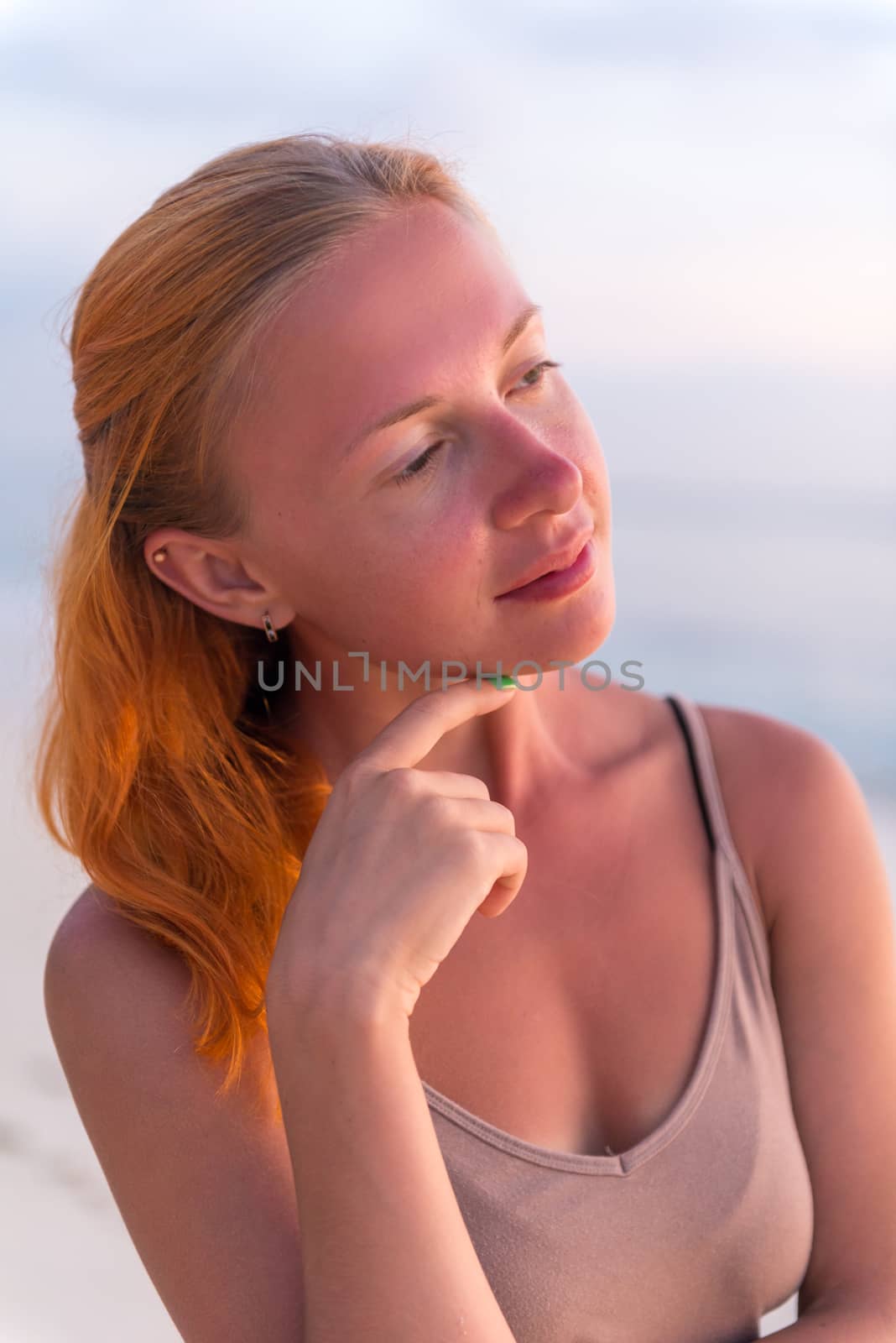 Young woman enjoying sunset view at tropical island beach