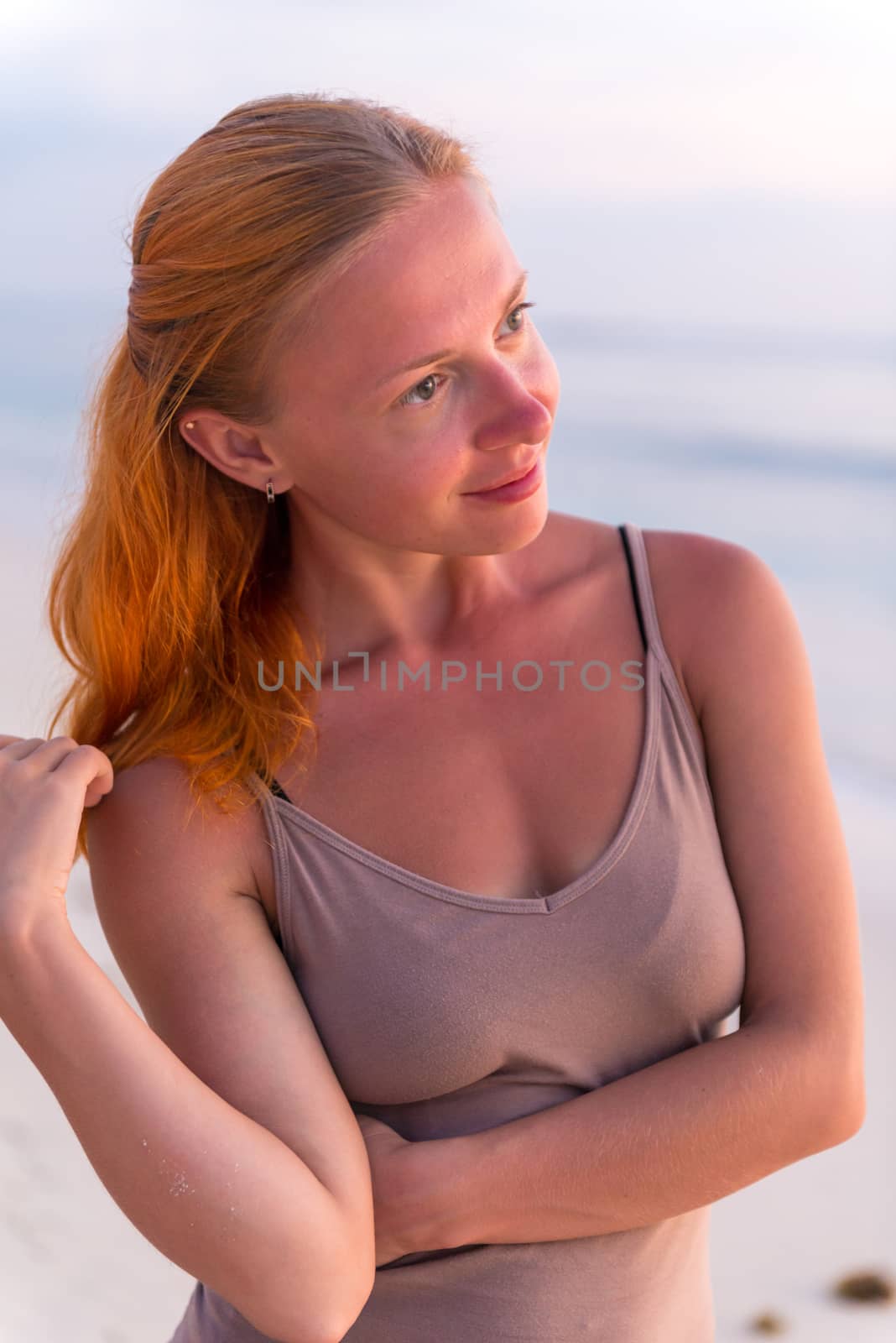 Young woman enjoying sunset view at tropical island beach