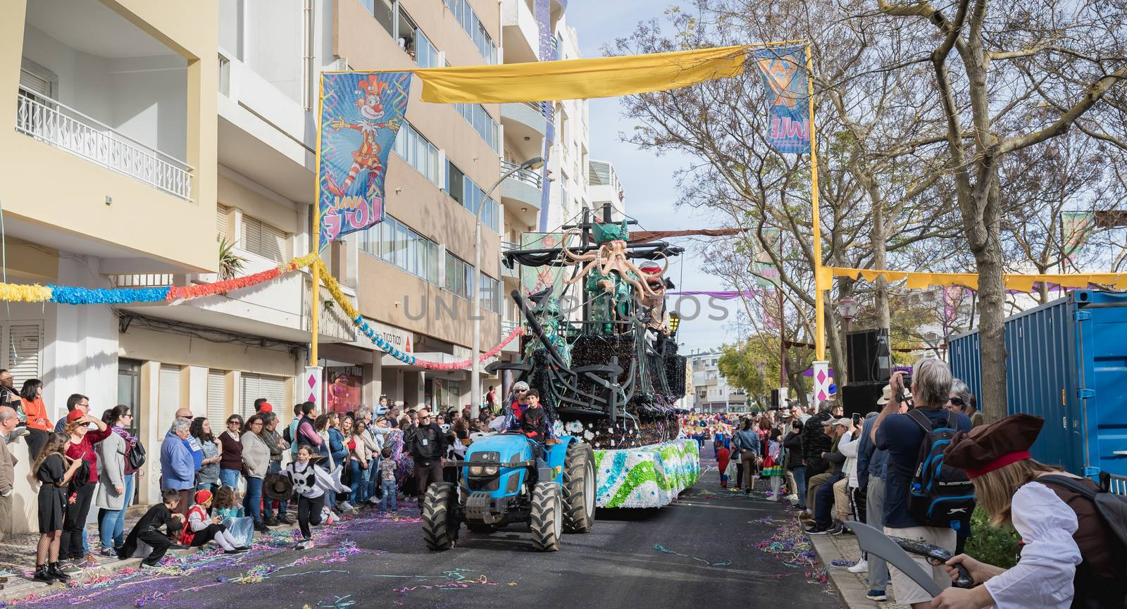 Loule, Portugal - February 25, 2020: Pirate ship float parading in the street in front of the public in the parade of the traditional carnival of Loule city on a February day