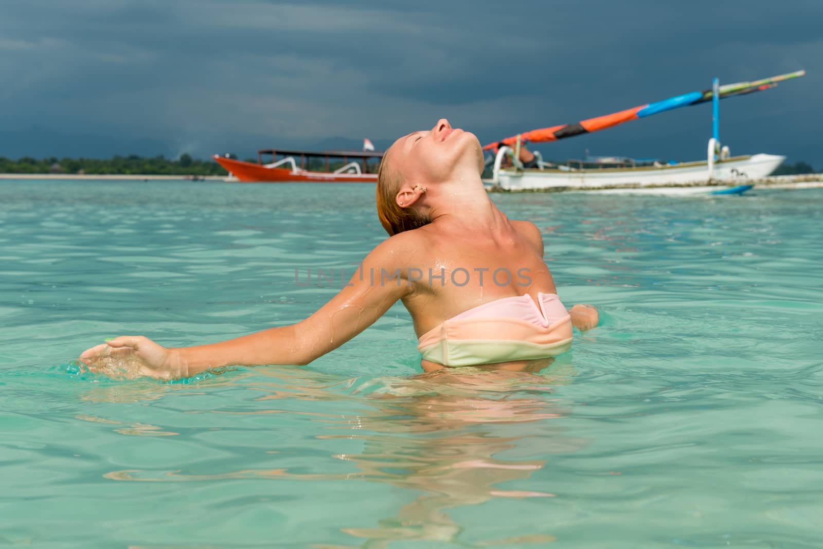 Woman at tropical island beach by nikitabuida