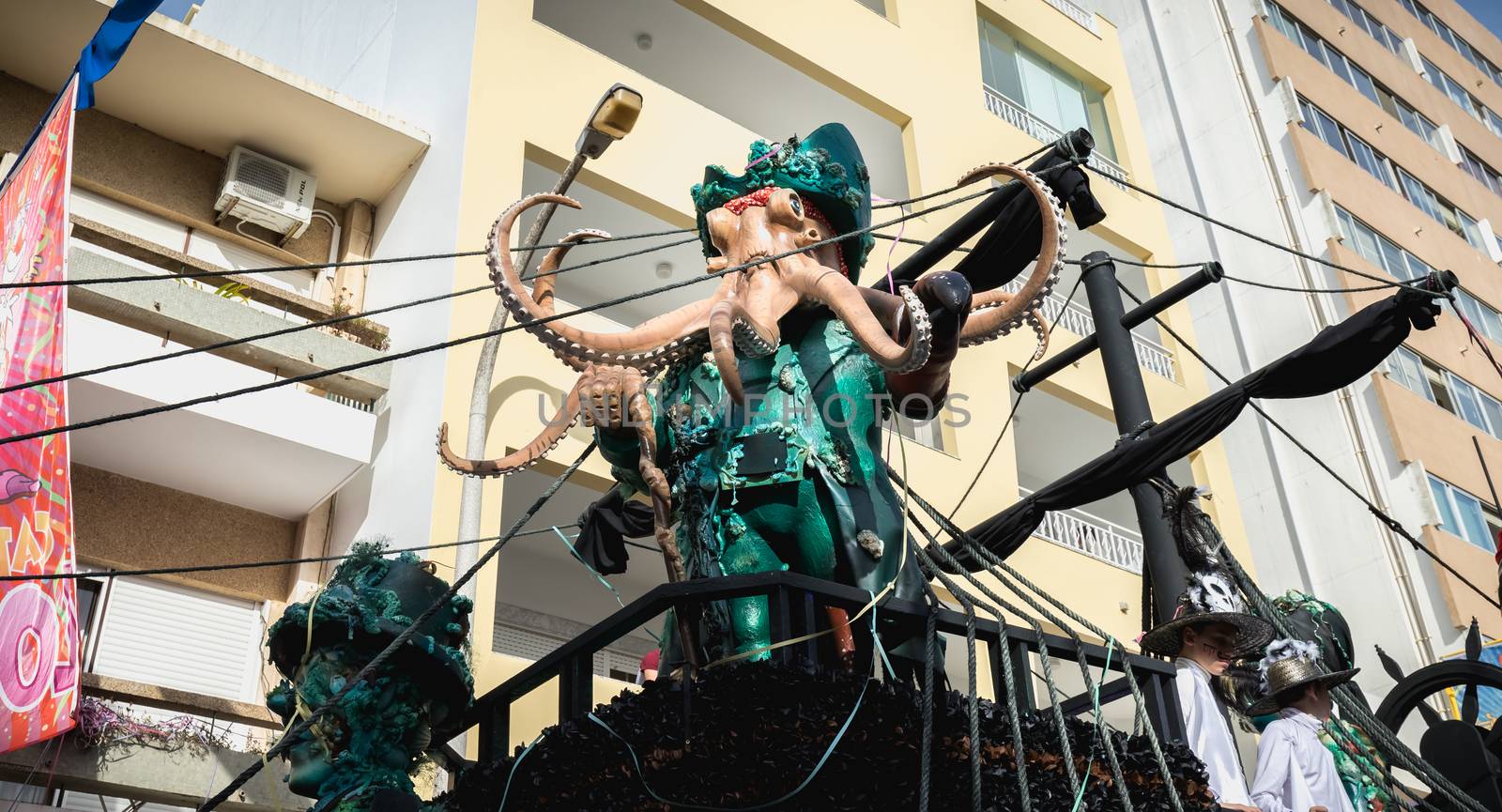 Loule, Portugal - February 25, 2020: Pirate ship float parading in the street in front of the public in the parade of the traditional carnival of Loule city on a February day