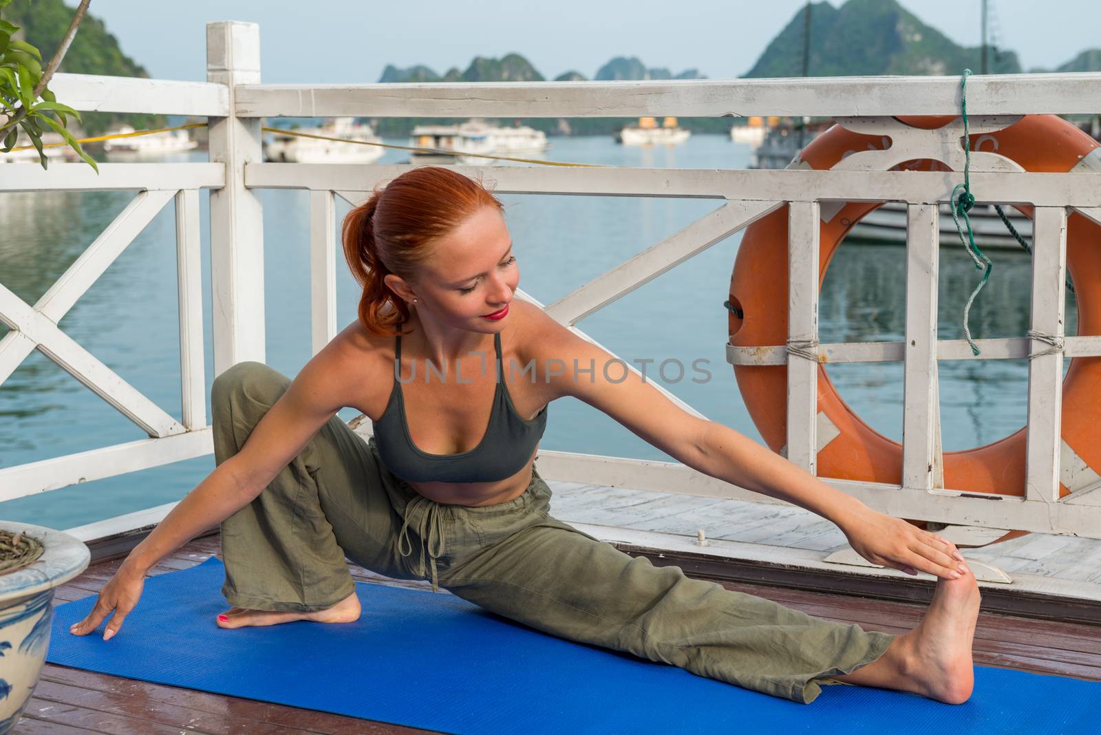 Young woman practicing yoga by nikitabuida