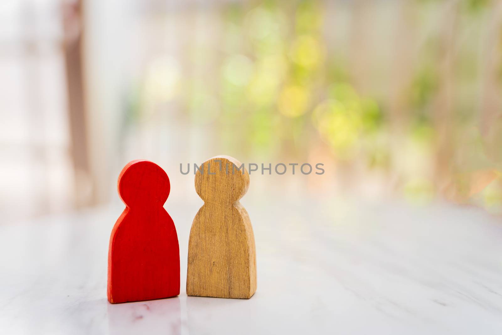 Figure in human resource management concept. The group of wooden puppets A red wooden figure like an dominant in a group with blur bokeh background

