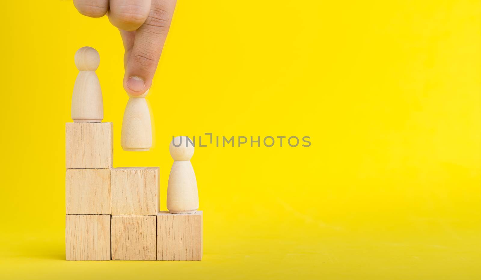 The hand is picking or select wood figure on the wooden  Stacked by Boophuket