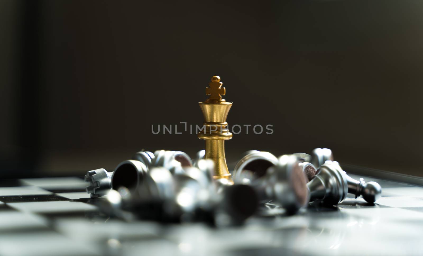 Golden King Chess wins in games with silver chess falling Defeat ed, in concept, business, victory, success and competition On the chess board with copy space selective focus at Golden King Chess
