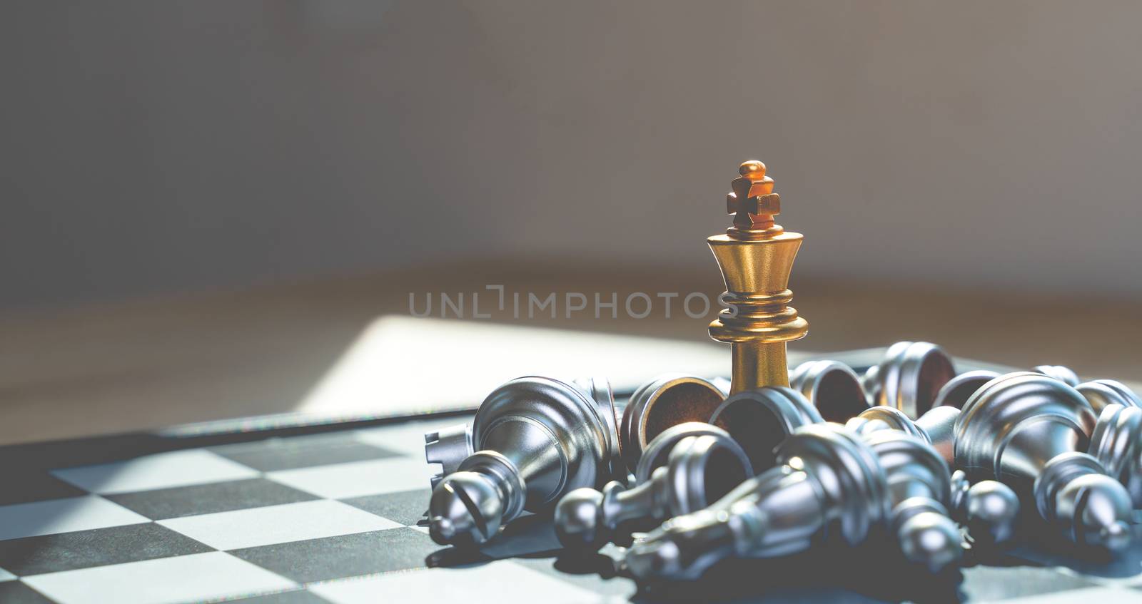 Golden King Chess wins in games with silver chess falling Defeat ed, in concept, business, victory, success and competition On the chess board with copy space selective focus at Golden King Chess