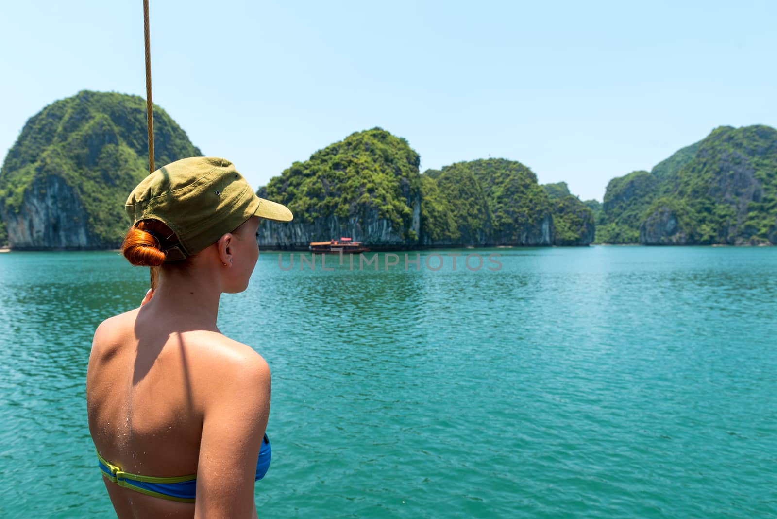 Tourist enjoying landscape with limestone mountains. Ha Long Bay, Vietnam