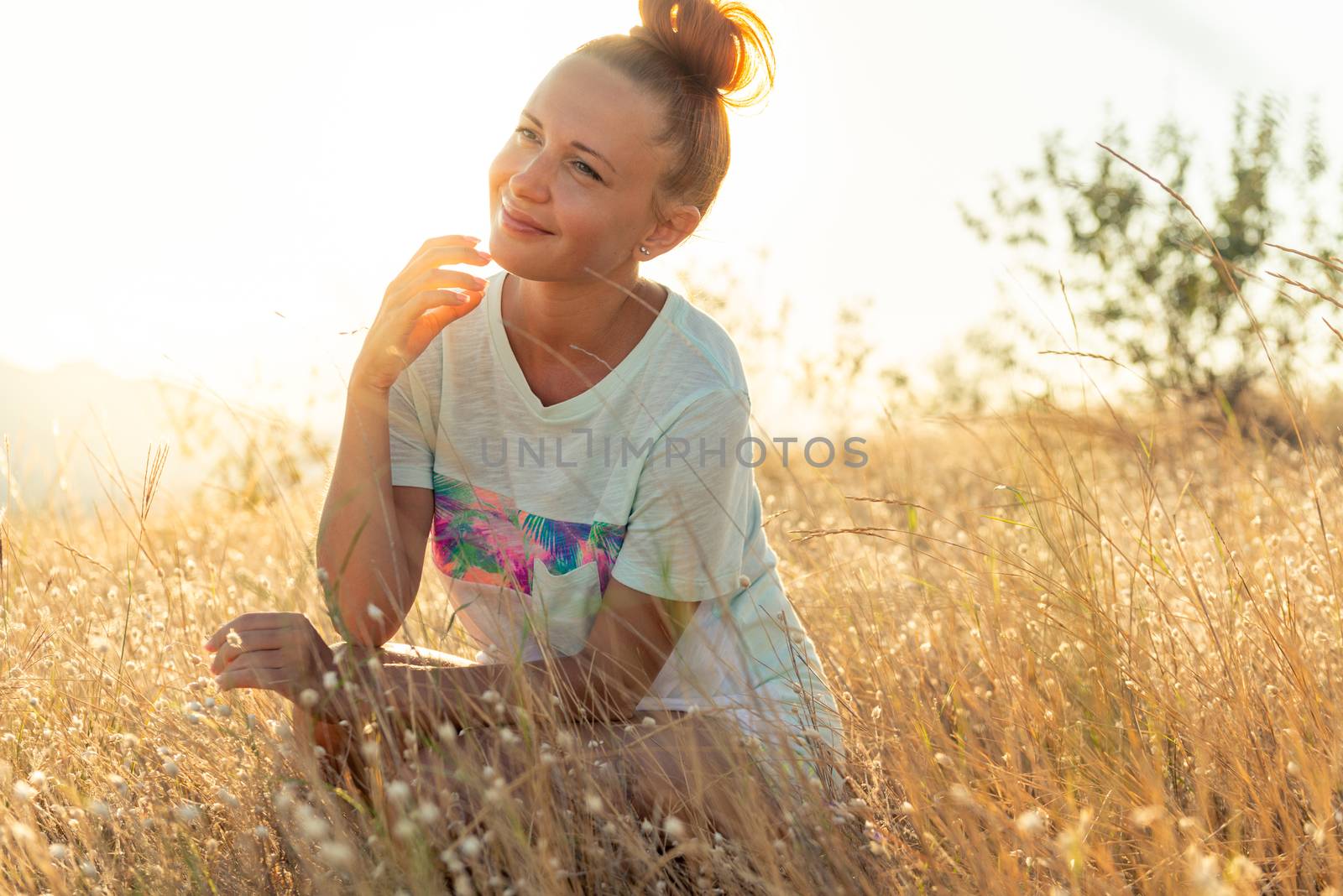 Beauty Girl Outdoors enjoying nature. Beautiful young model girl wearing sports clothes. Glow Sun. free happy woman