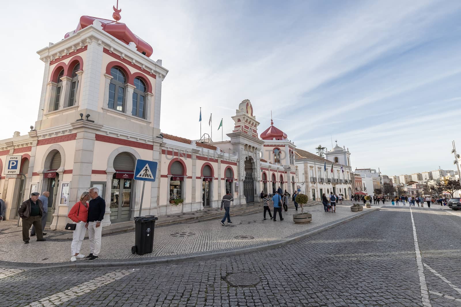 Loule, Faro, Portugal - February 25, 2020: people walking in front of the city's municipal market on a winter day