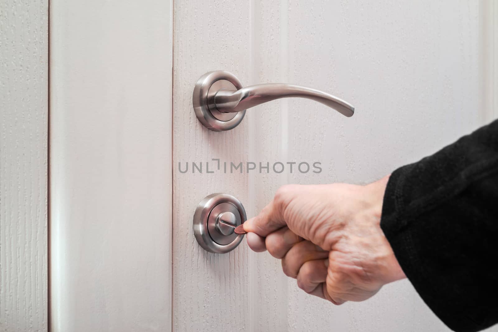 Opening or closing a safety lock on the toilet door