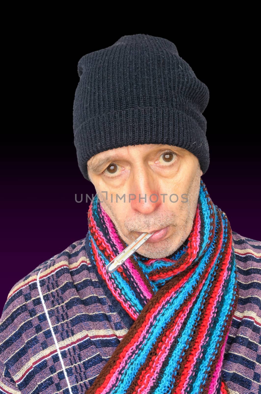 Sick man with the flu and temperature, wearing a cap and a woolen scarf, on dark background