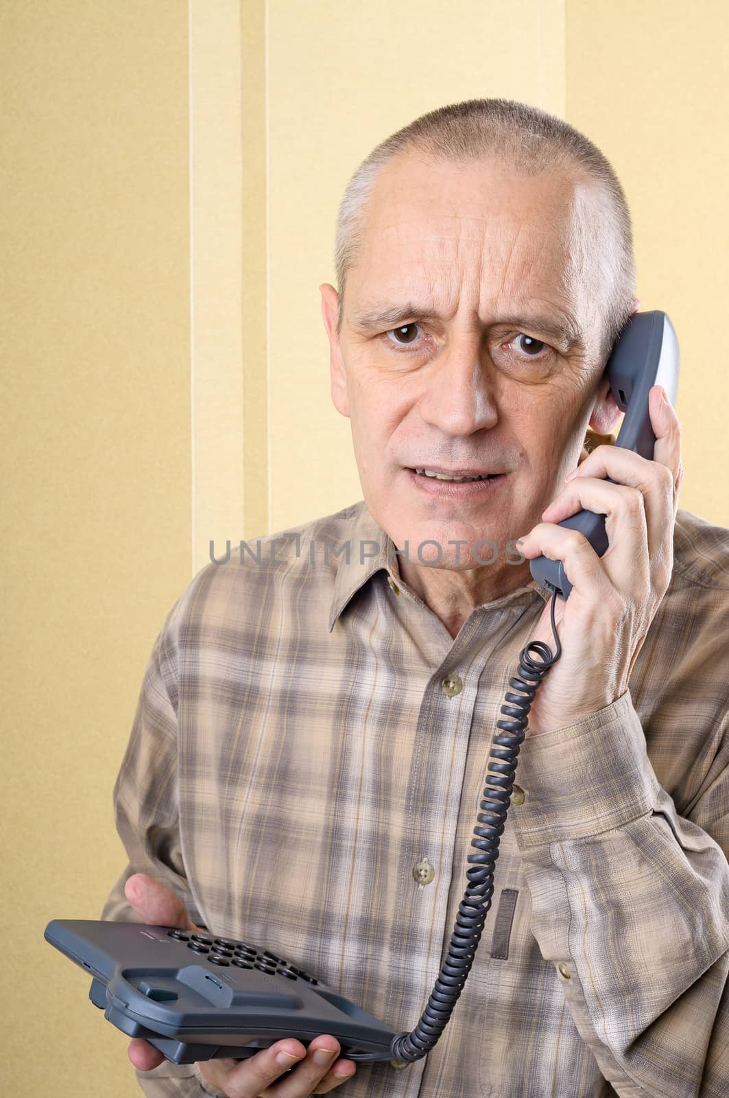Upset man having bad news and holding a phone in hand