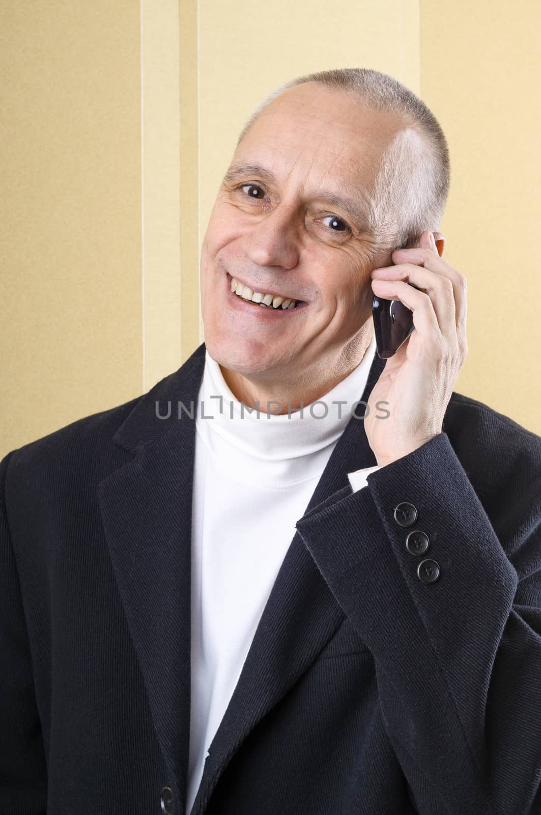 Happy businessman having good news on mobile phone