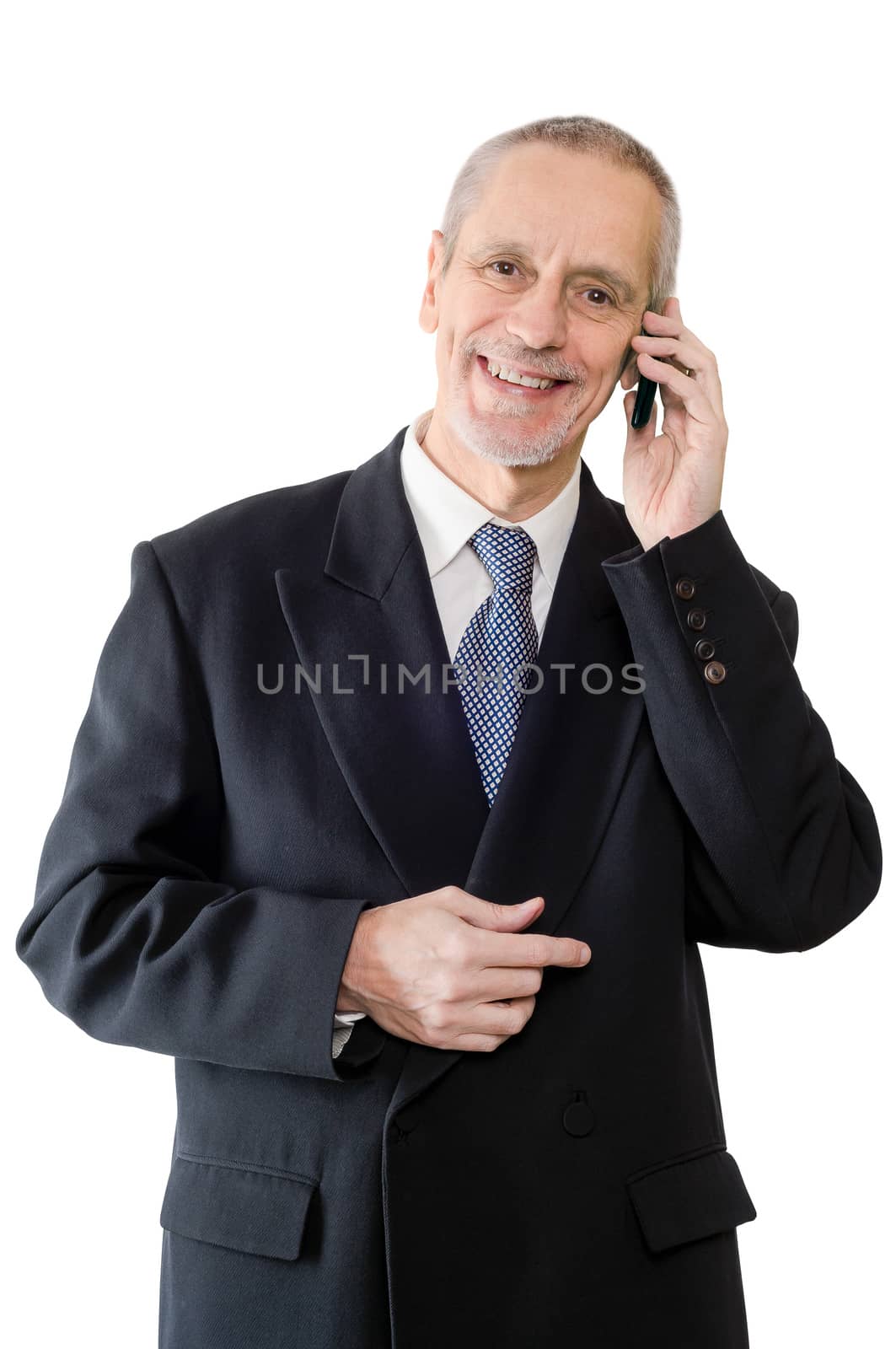 An amiable businessman smiling on mobile phone