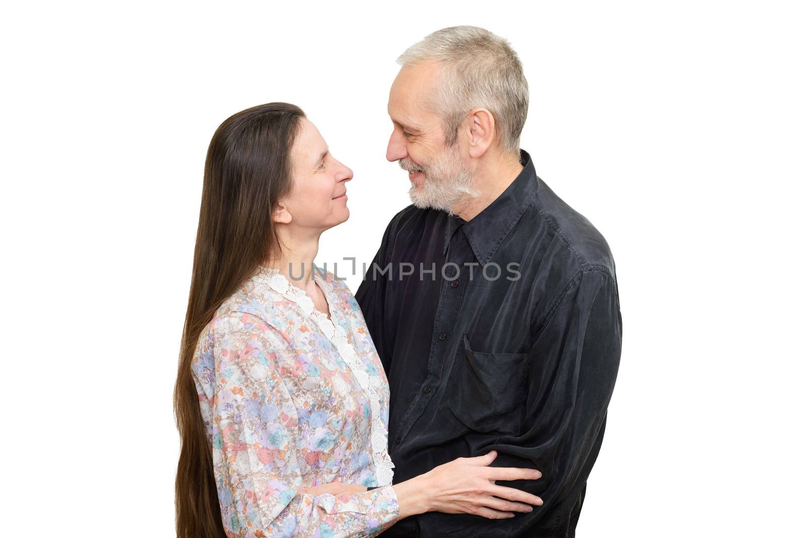 Mature man and woman with long hair looking at each other with love, eyes in eyes, for S. Valentine's day or anniversary. Isolated on white background.