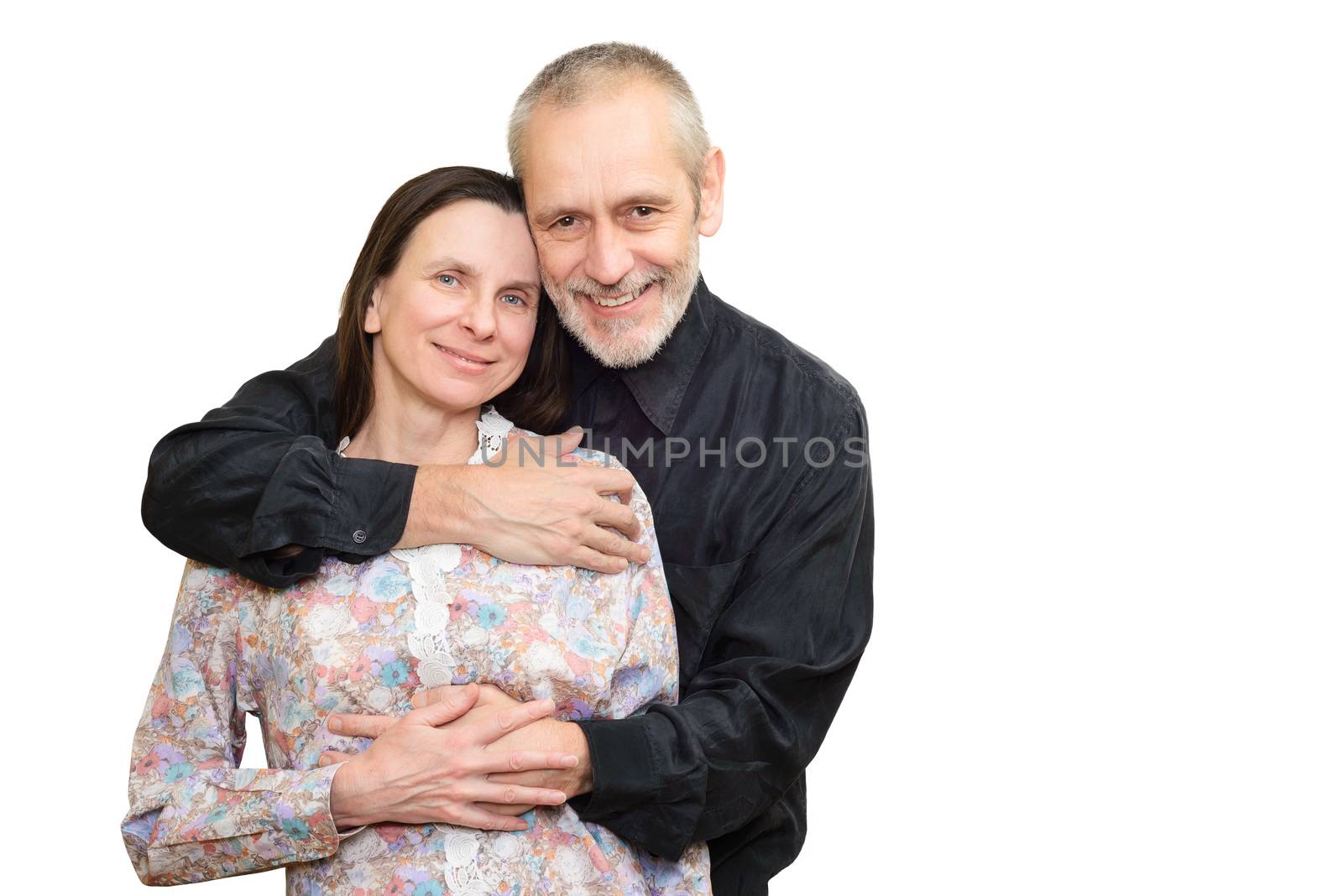 Happy mature man and woman smiling for S. Valentine's day or anniversary and embracing each other. Isolated on white background.