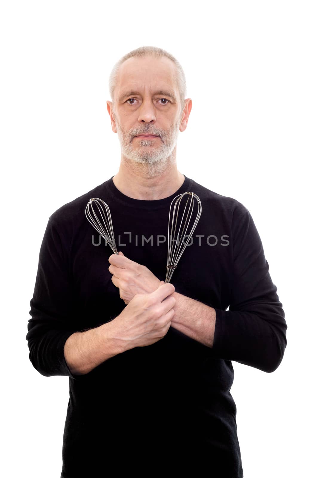 Adult man in black holds a whip in each hand and looks serious