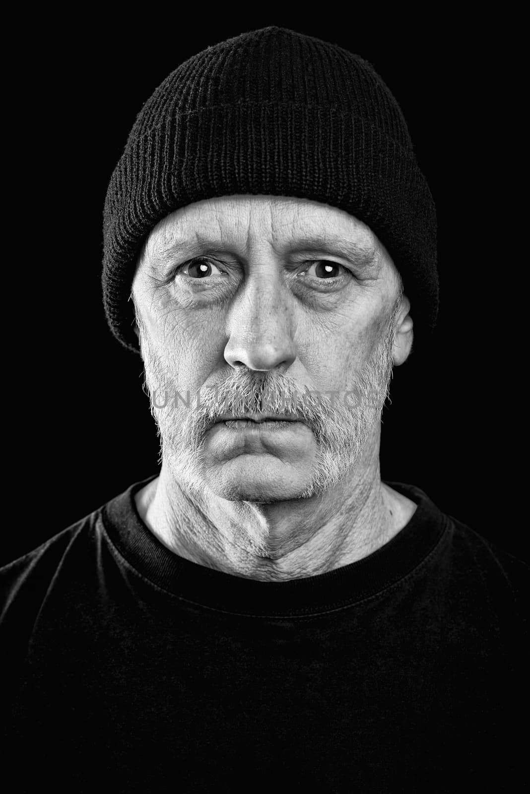 Dramatic black and white photo of a man with a beard and a woole by MaxalTamor