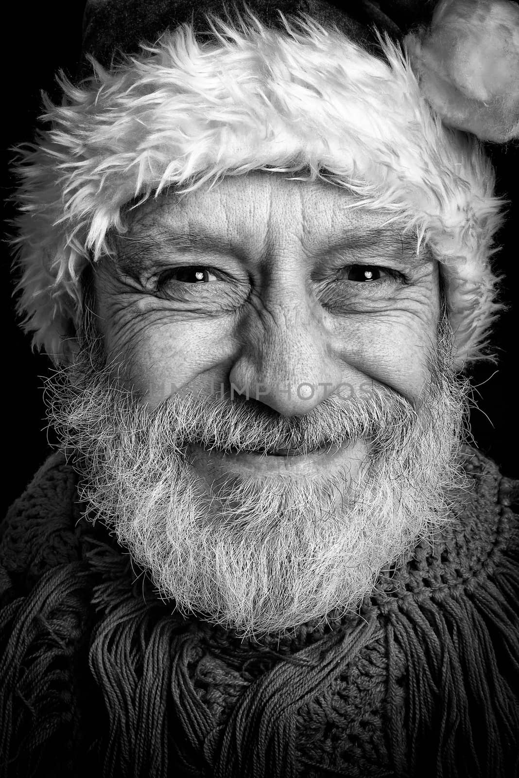 Black and white portrait of an adult man with white beard disguised in Santa Claus for the Christmas Holiday