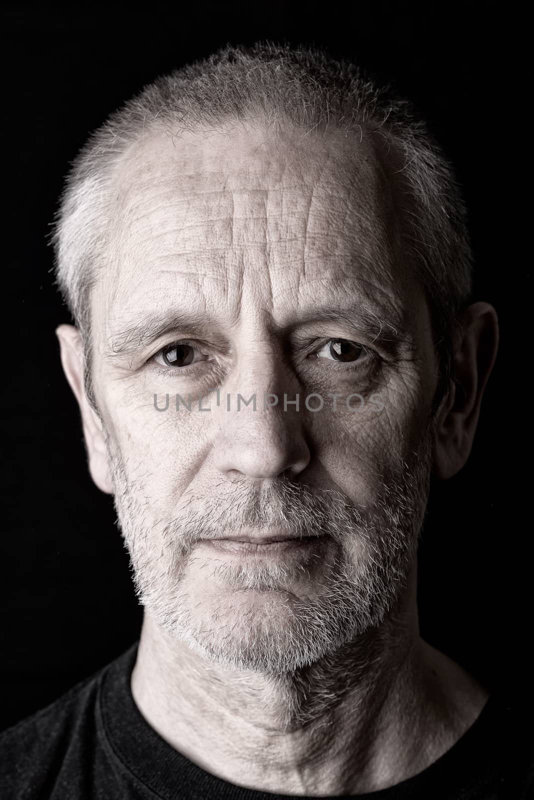 Portrait of a serious and confident man with a penetrating gaze and a bit of sadness in the eyes