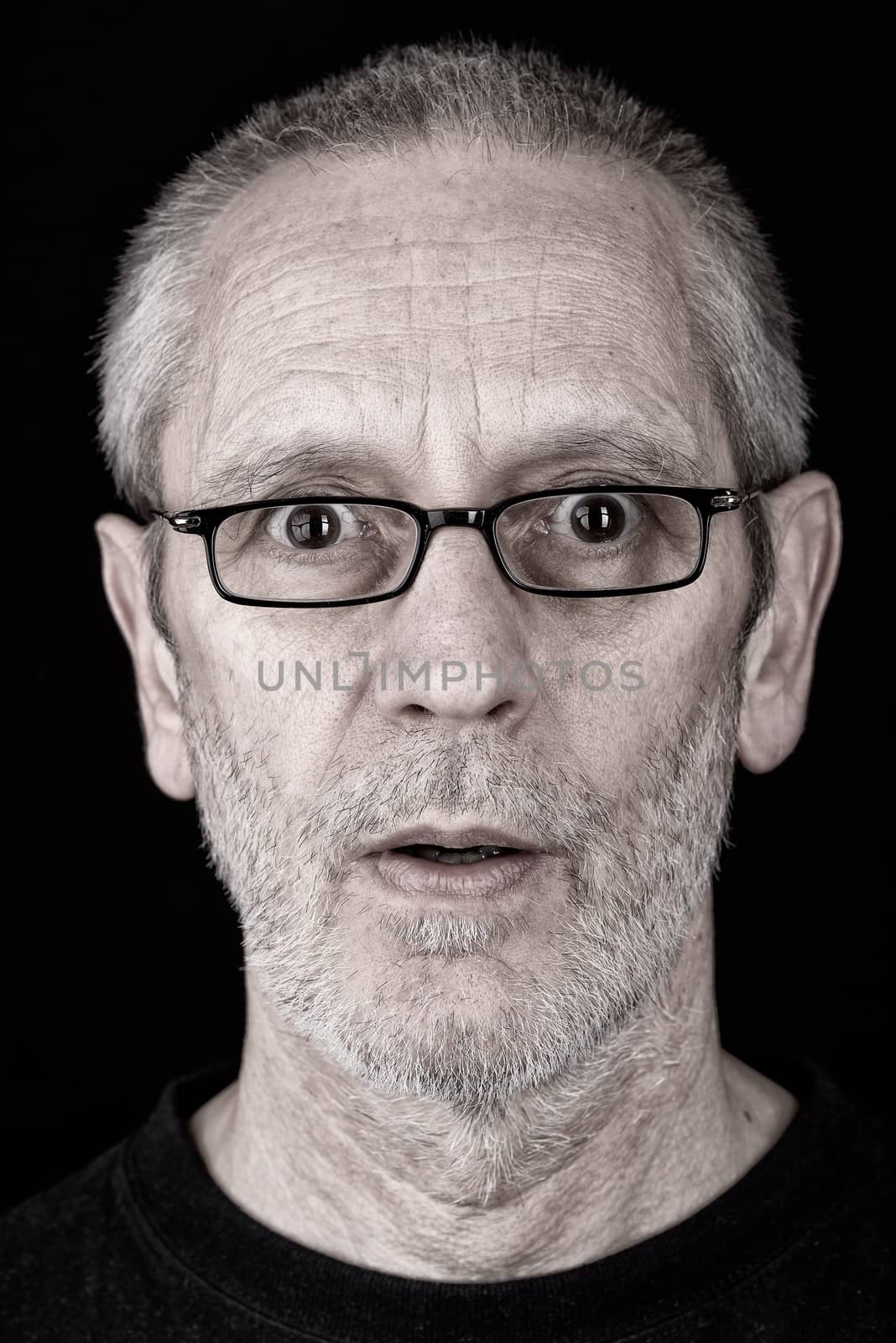Portrait of a surprised and confident man wearing glasses, with open mouth