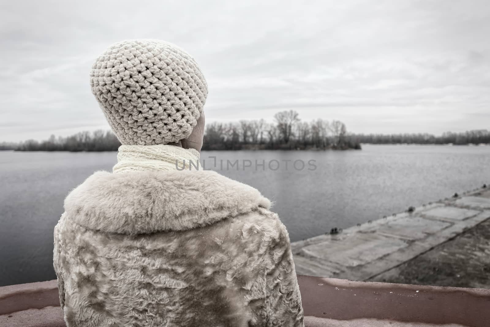 Woman Looking at the River during a Sad Winter Day by MaxalTamor