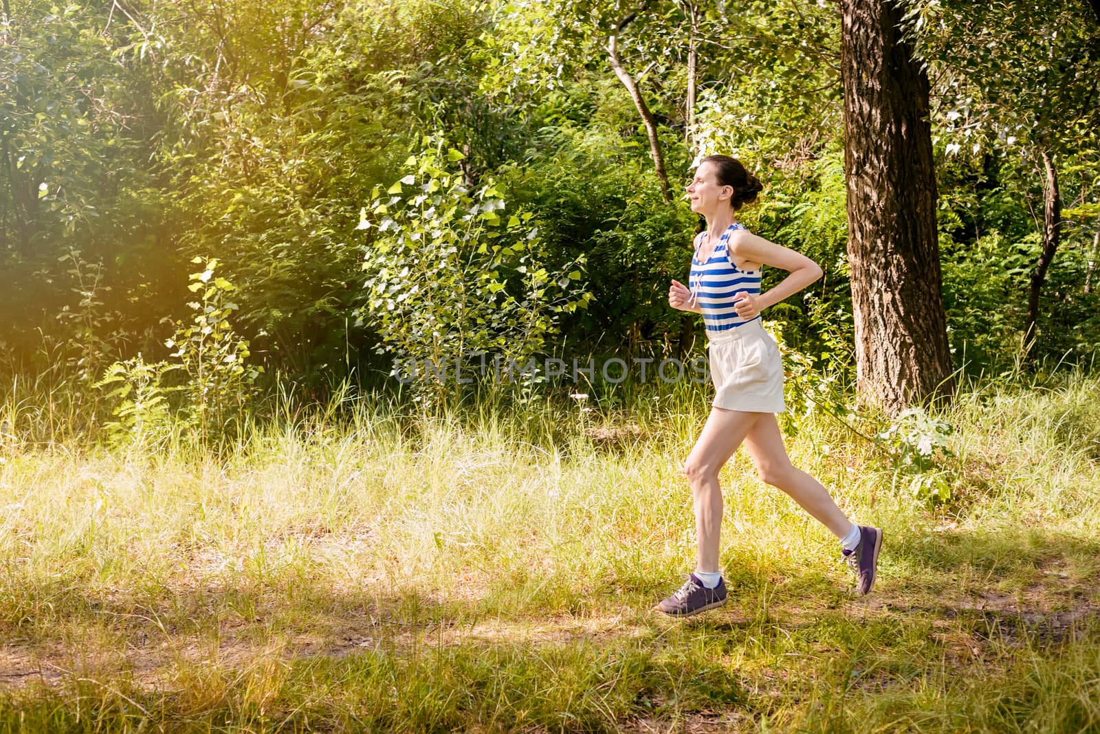 Senior Woman Running in the Forest by MaxalTamor
