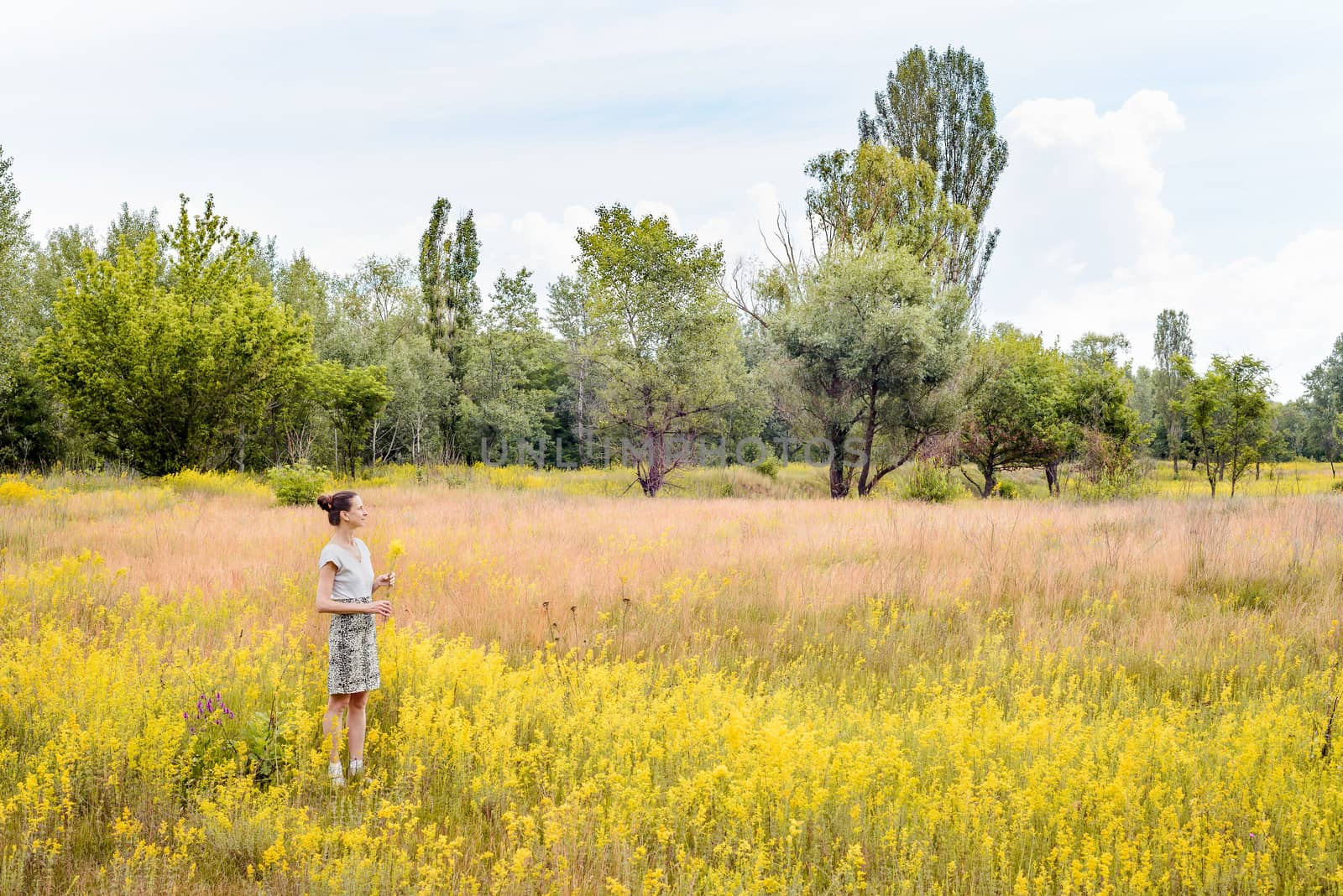 Woman Standing in a Field of Galium Verum by MaxalTamor