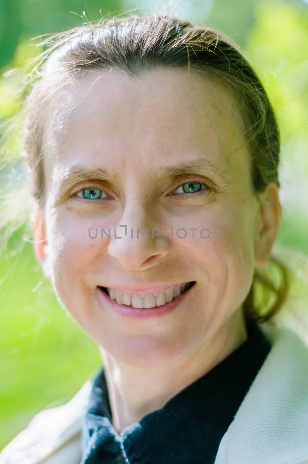 Natural portrait of a mature woman smiling under the spring un