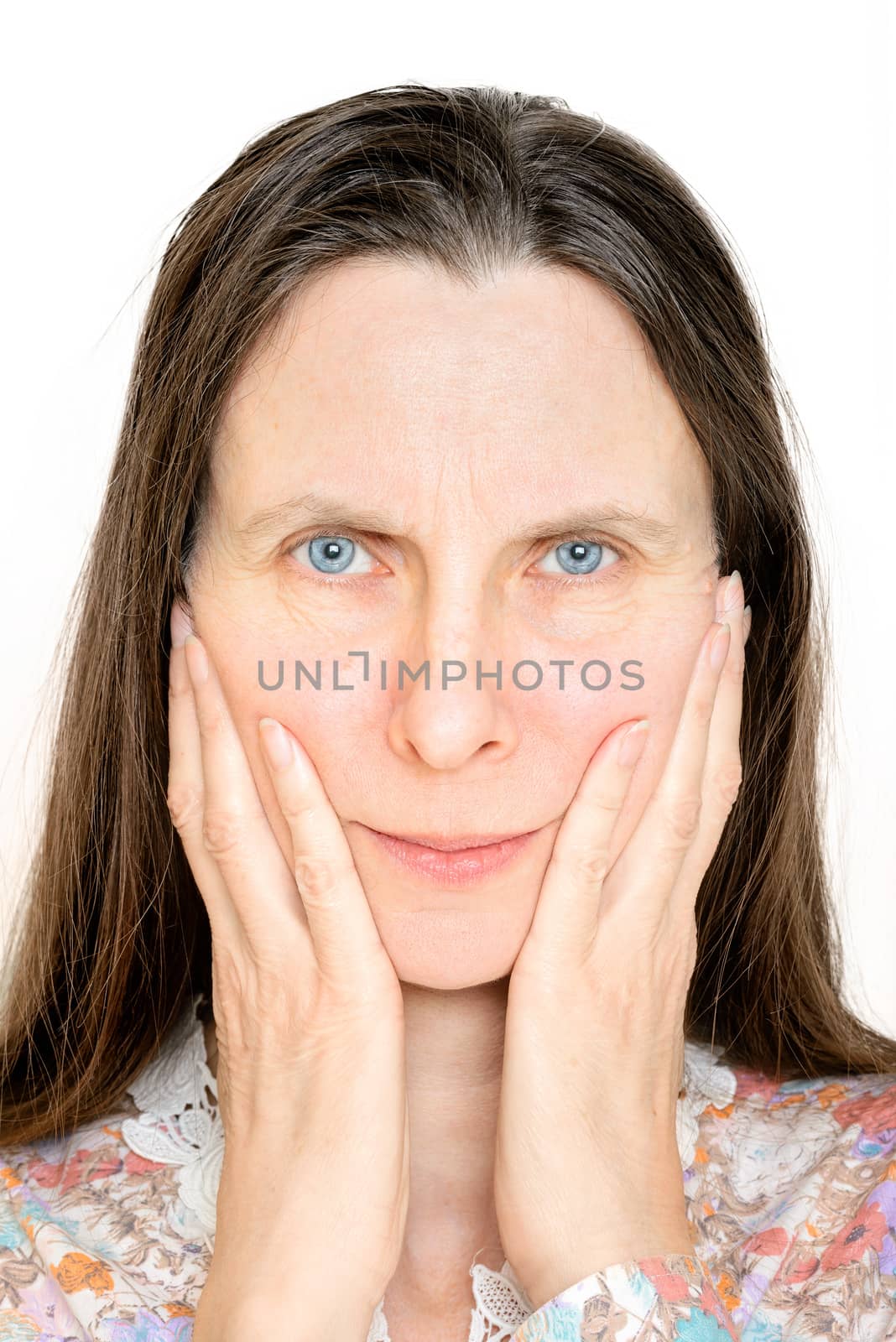 An angry senior woman portrait, with the hands on the face