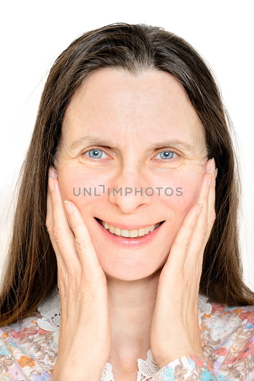 Portrait of a happy smiling mature woman, with the hands on her face