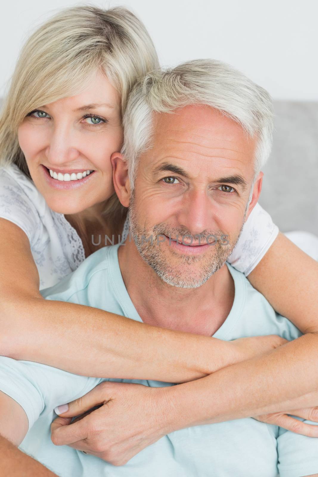 Closeup portrait of a loving mature couple in bed at home