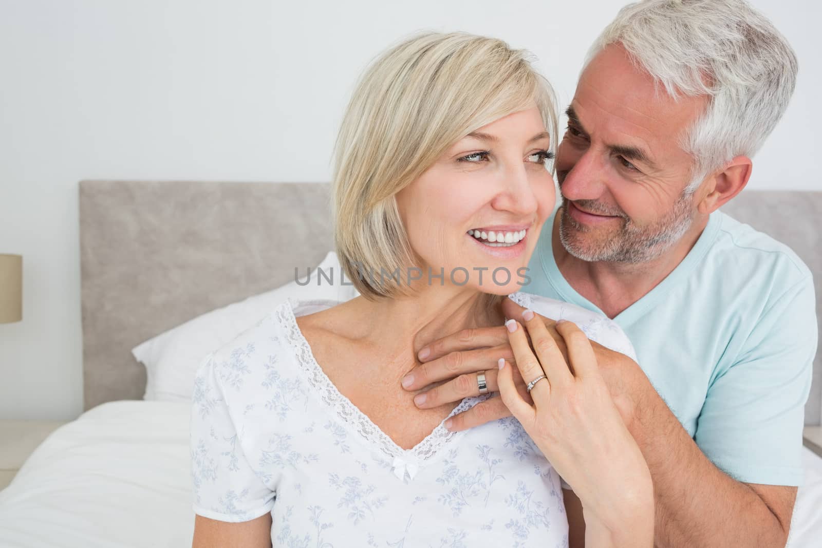 Closeup portrait of a loving mature couple in bed at home