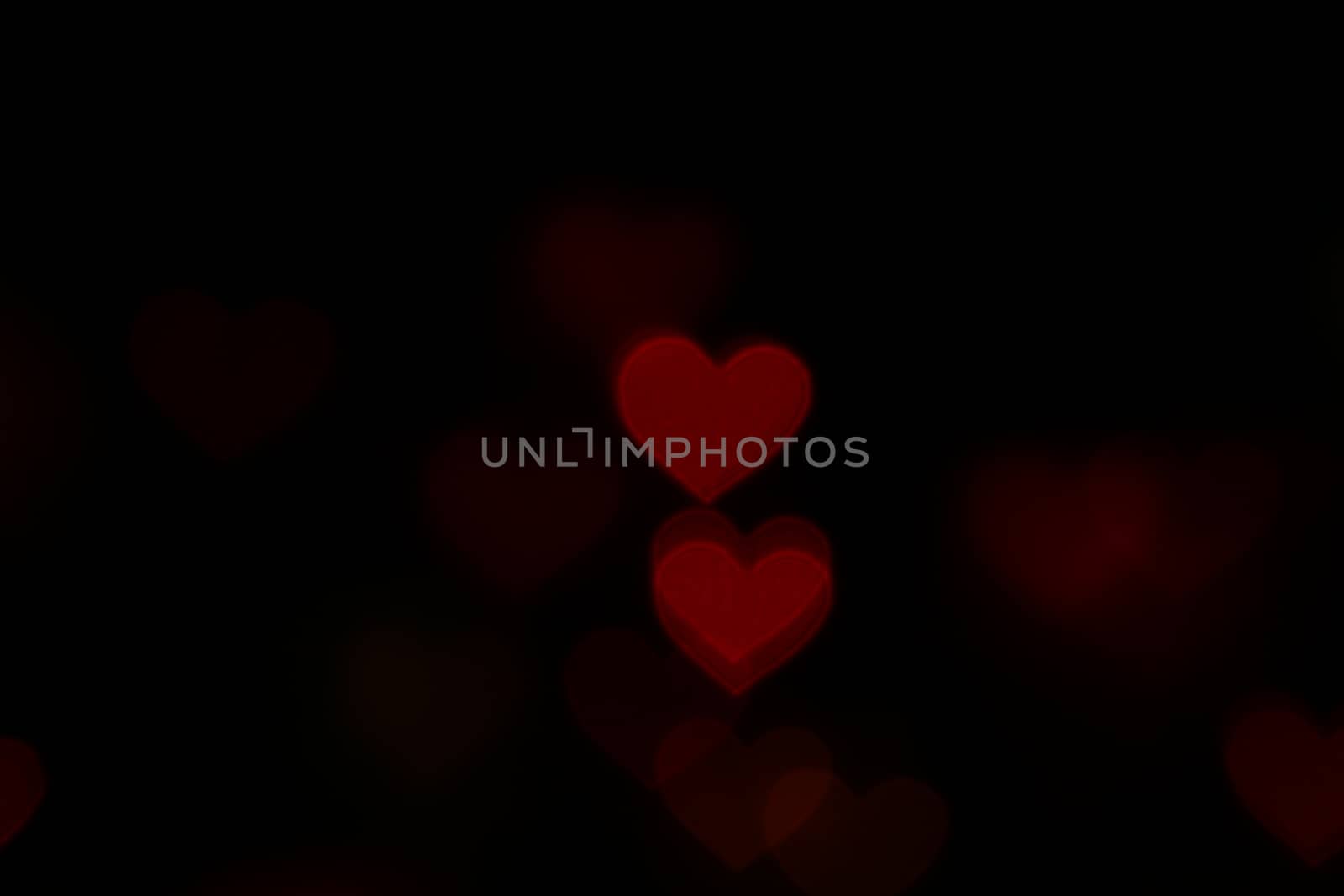 Valentine Red heart-shaped on black background Colorful lighting bokeh for decoration at night backdrop wallpaper blurred valentine, Love background, Lighting heart shaped soft night abstract