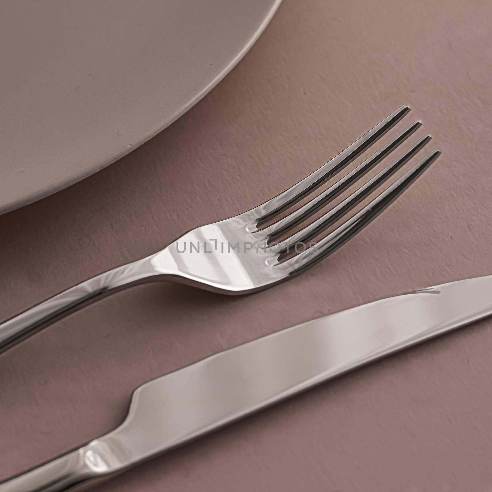 Empty plate and cutlery as mockup set on brown background, top tableware for chef table decor and menu branding design