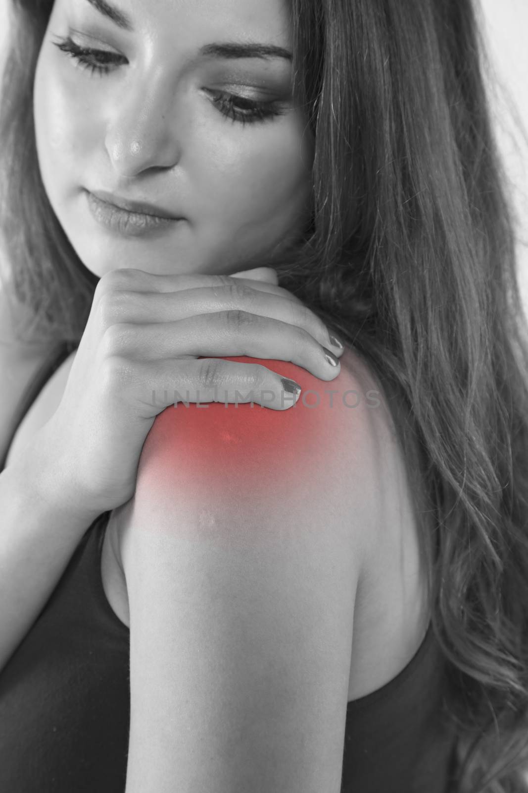 A young woman is struggling with pain, isolated on background