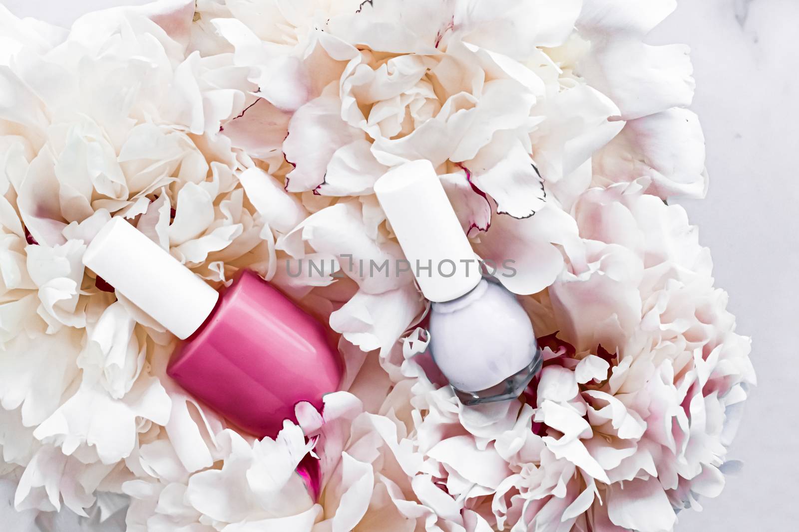 Nail polish bottles on floral background, french manicure and cosmetic branding design