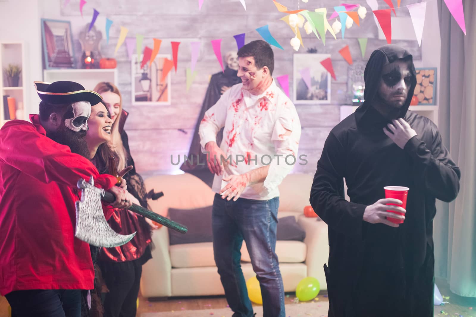 Man dressed up like an angry grim reaper at halloween celebration.