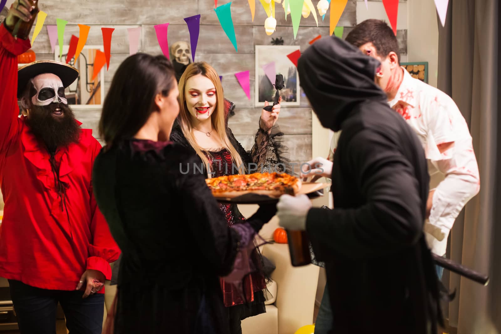 Group of friends excited about delicious pizza by DCStudio