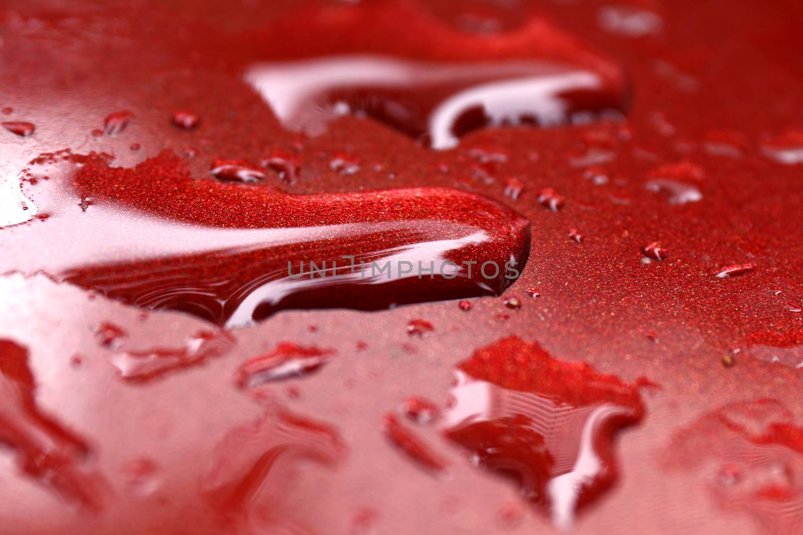 water droplets wet on red car's surface hood, water drop on red texture, water drop wet close-up (selective focus)