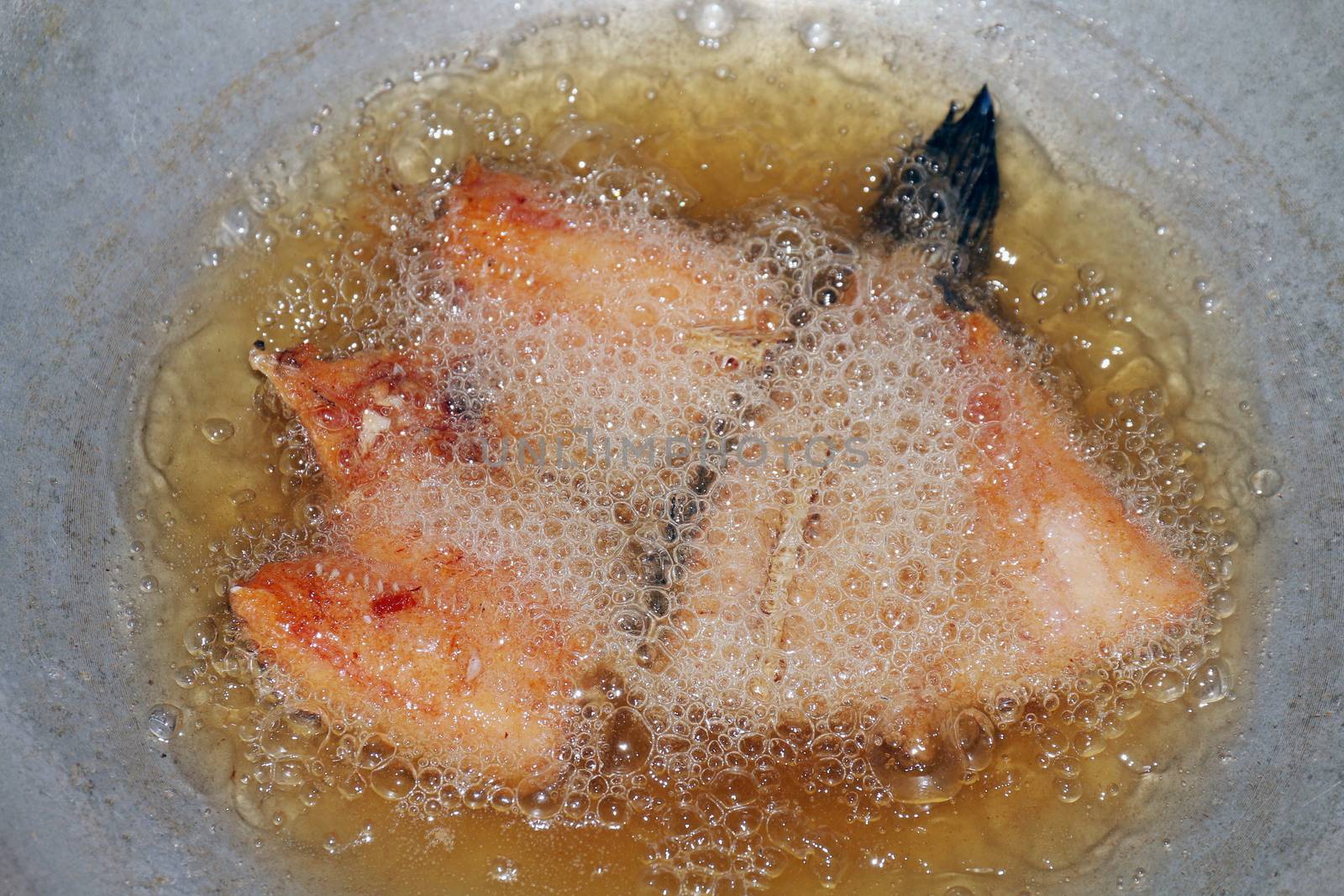 Fried fish pieces in hot oil pan, Fried fish for diet, Fish cutting Portion slice fried in oil cooking pan is food protein diet health