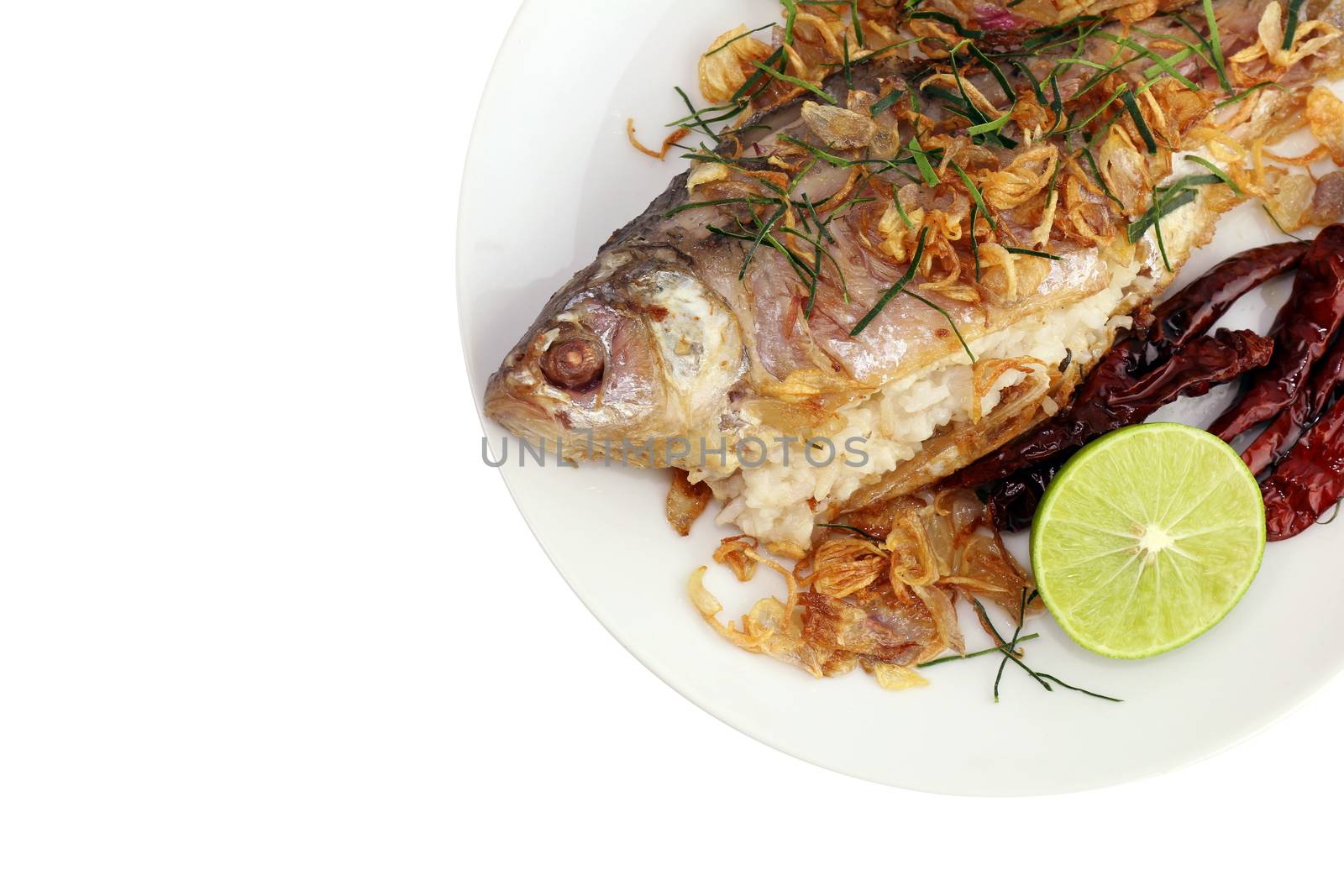pickled fish tasty fried (pla som tod : thai word), pickled fish fry and fried onion, lime slice, and fried chili served with fresh vegetable on white background