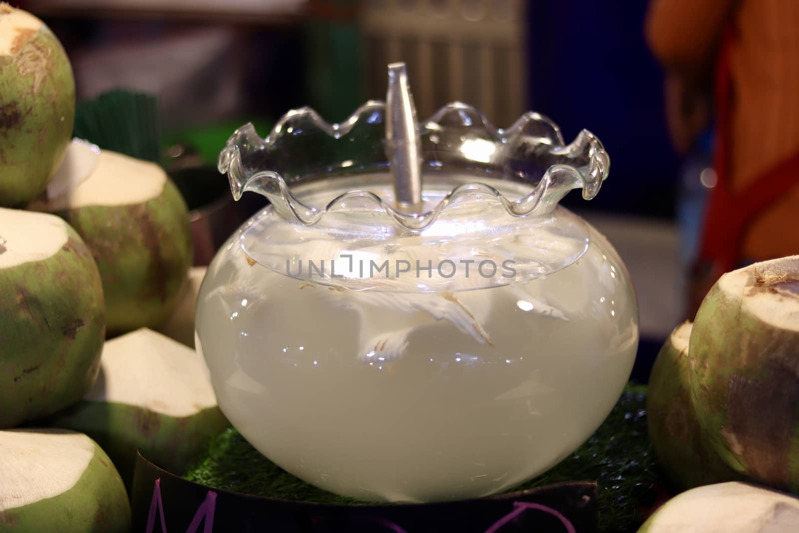 coconut, coconut juice, coconut water for drink in shop, coconut water in transparent jar at night pedestrian street market