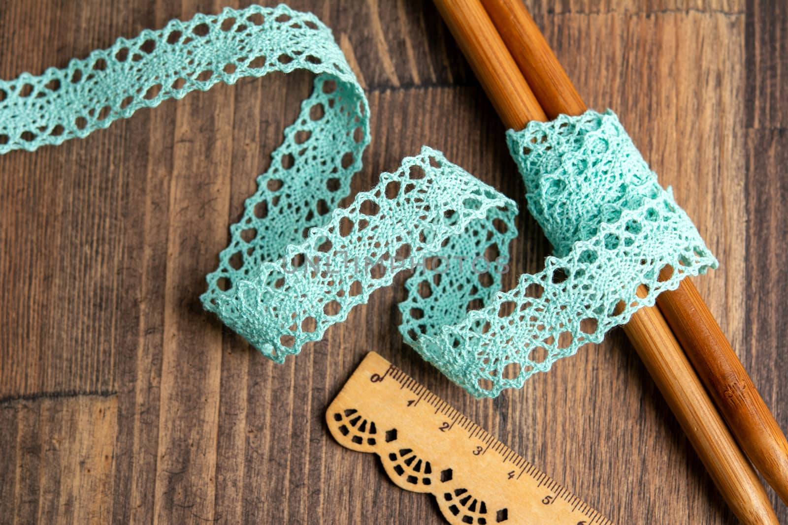 knitted emerald openwork linen ribbon tapes in rural style of rustics cotton eco natural on wood ground