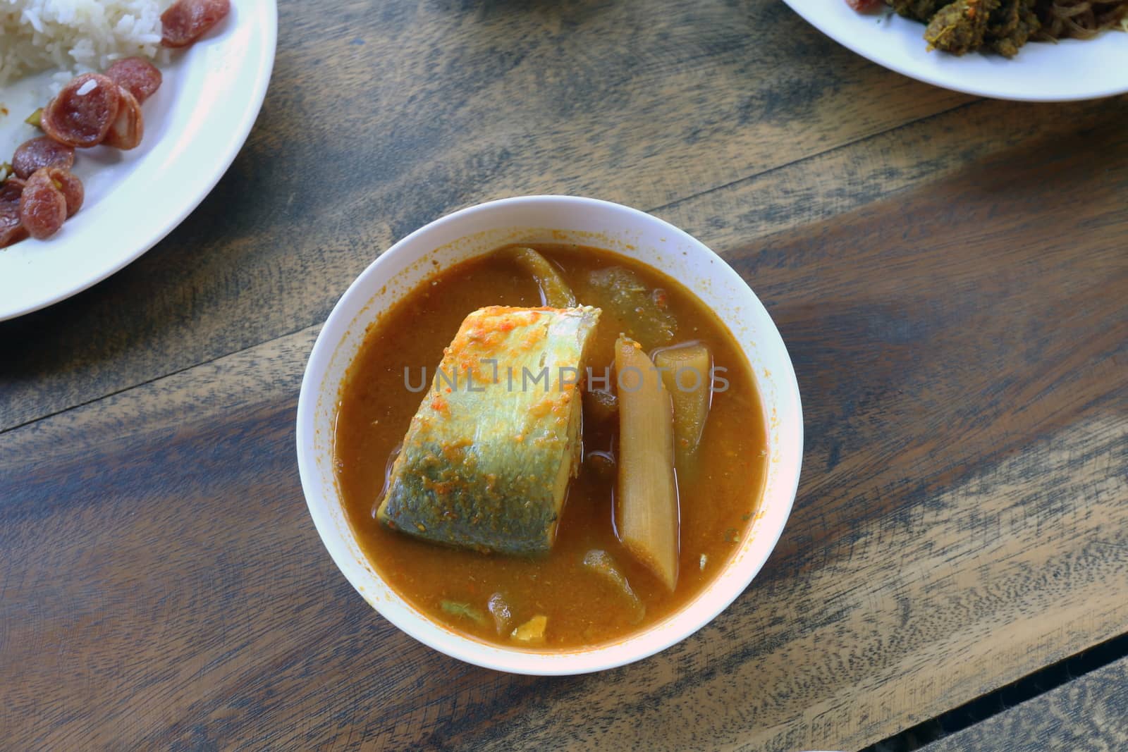 Yellow curry fish in bowl white thai southern style food, khaw khang-ti (Thai word), Large pieces of fish soup in a cup is Thai Asia food Popular Diets