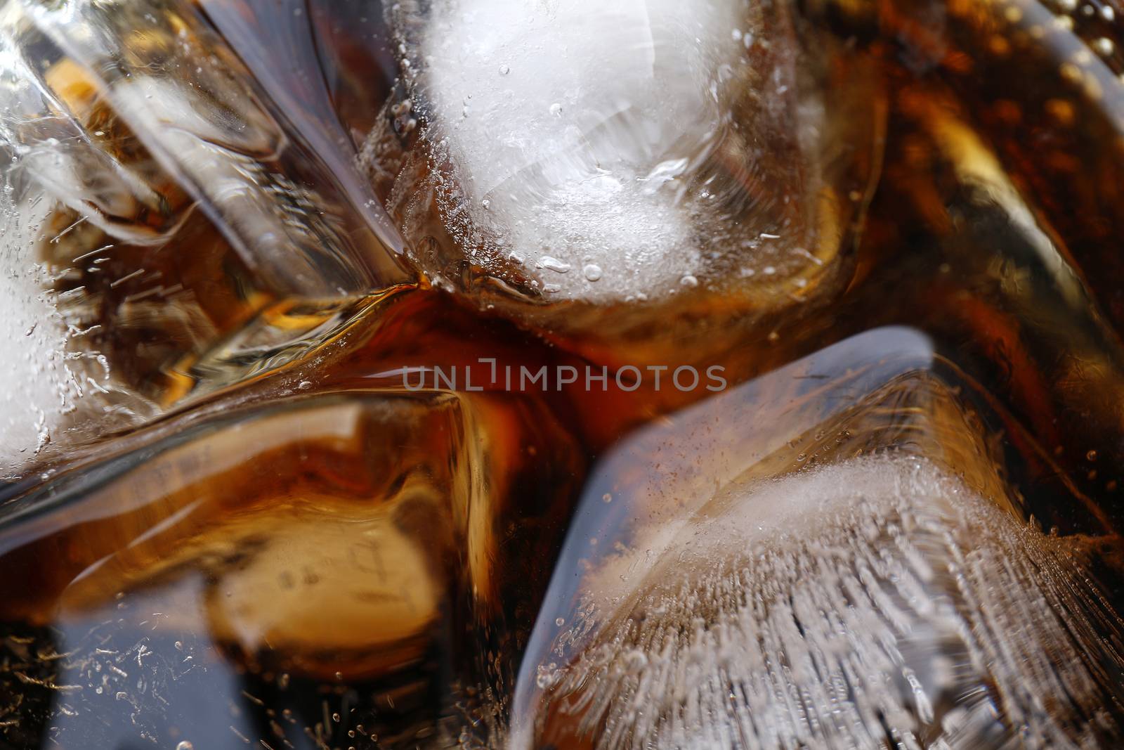close-up beverage cola and cubes ice refreshing cool in glass, black cola soda in glass with ice cubes for refreshments feel for background