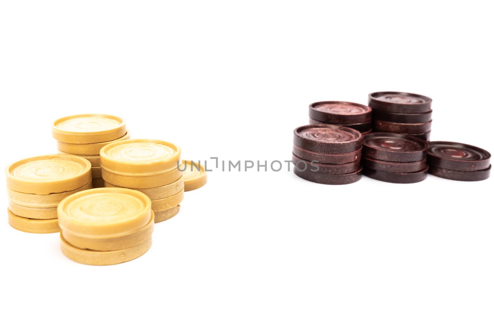 low-end plastic round checkers piece in white background in studio